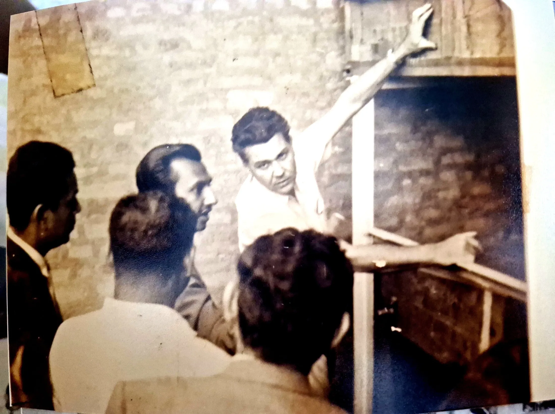 Men study a timber test rig; an engineer reaches up to the frame.